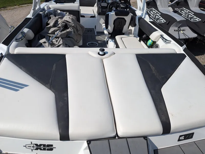 Slide: The Image of 2019 Axis A22 boat interior with white and black seating, showcasing sleek design and comfort. - 5