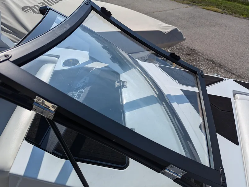 Slide: The Image of 2019 Axis A22 boat windshield with sleek black frame and clear glass. - 7