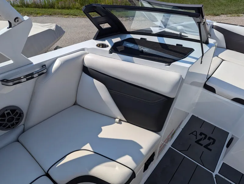 Slide: The Image of 2019 Axis A22 boat interior with white and black seating, windshield, and speaker. - 8
