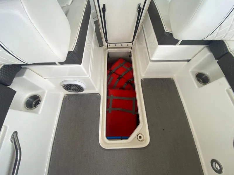Slide: The Image of 2017 Sea Ray 270 SDX OB boat interior with storage compartment and life jackets. - 35