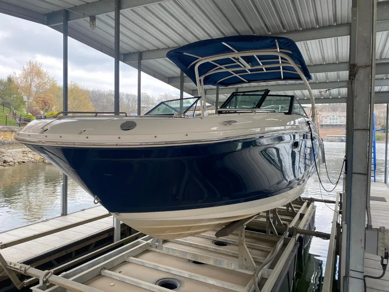 Slide: The Image of 2017 Sea Ray 270 SDX OB boat docked under a covered marina. - 40