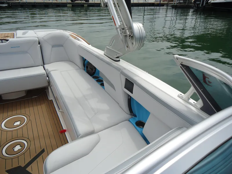 Slide: The Image of 2021 MasterCraft XStar boat interior with white seating and teak flooring. - 17