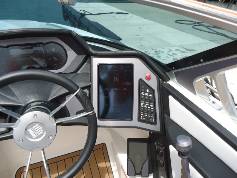 Slide: The Image of 2021 MasterCraft XStar dashboard with steering wheel and digital controls. - 21