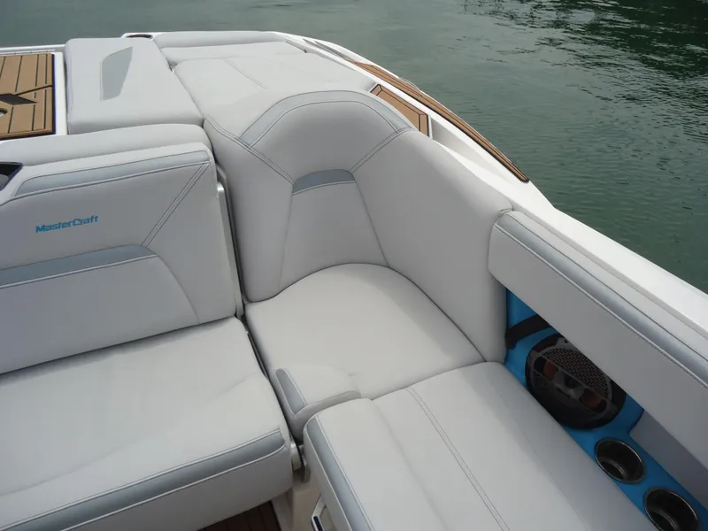 Slide: The Image of 2021 MasterCraft XStar boat interior with white leather seating and cup holders. - 24