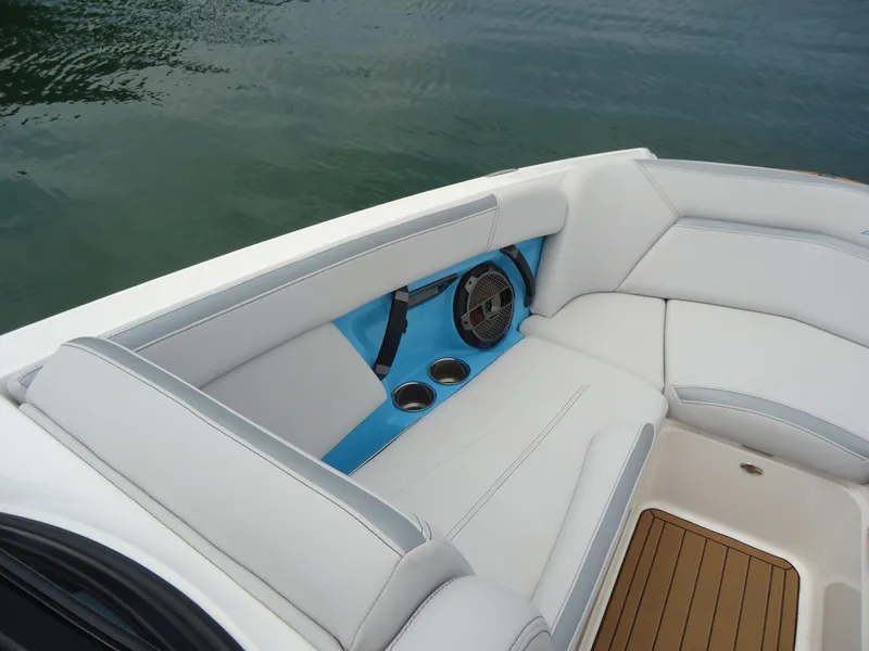 Slide: The Image of 2021 MasterCraft XStar boat interior with white seating and blue accents. - 28