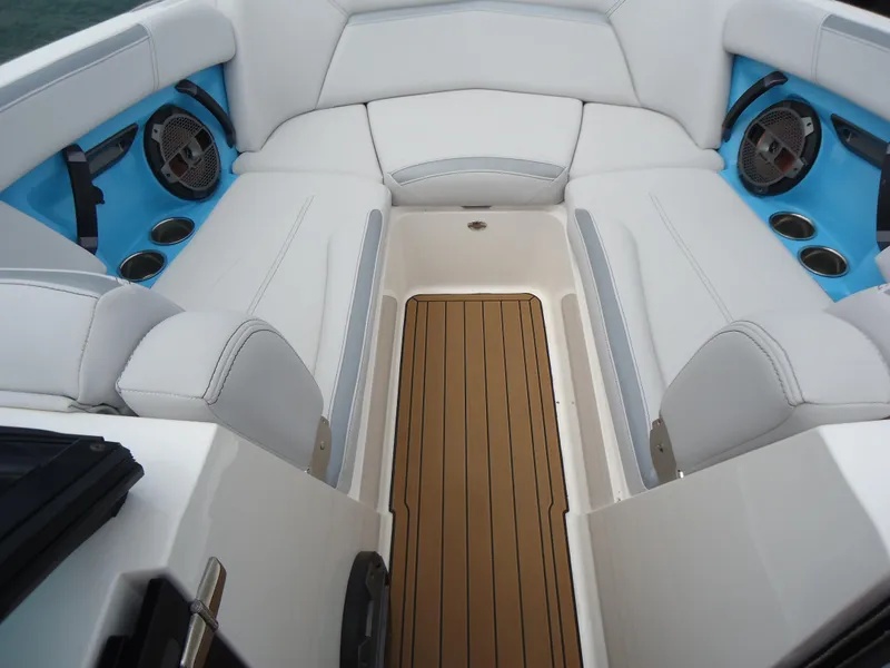 Slide: The Image of 2021 MasterCraft XStar boat interior with white seating and blue accents. - 29