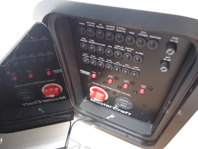 Slide: The Image of Control panel of a 2021 MasterCraft XStar boat with various switches and indicators. - 30