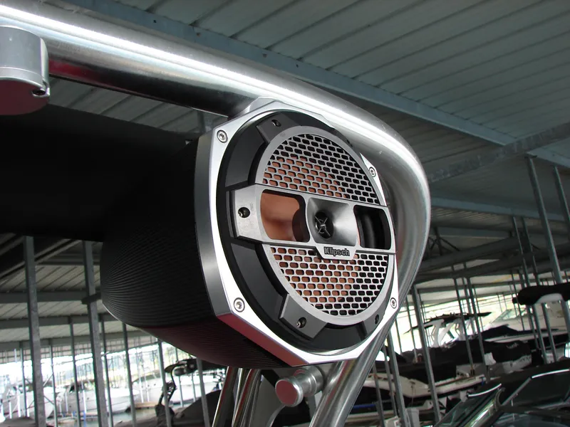 Slide: The Image of Speaker mounted on a 2021 MasterCraft XStar boat under a metal canopy. - 31