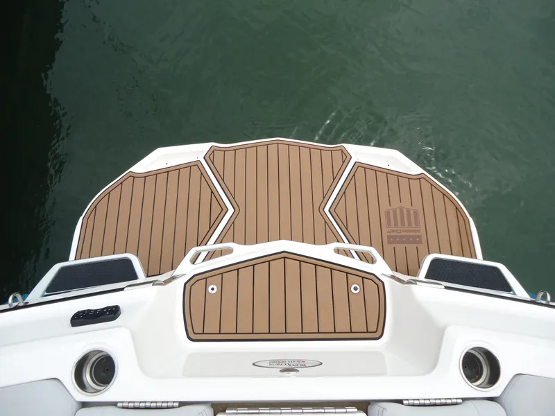 Slide: The Image of 2021 MasterCraft XStar swim platform with teak decking on calm water. - 7