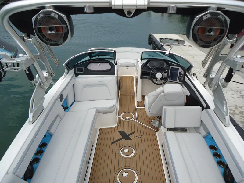 Slide: The Image of 2021 MasterCraft XStar boat interior with luxurious seating and advanced audio system. - 8