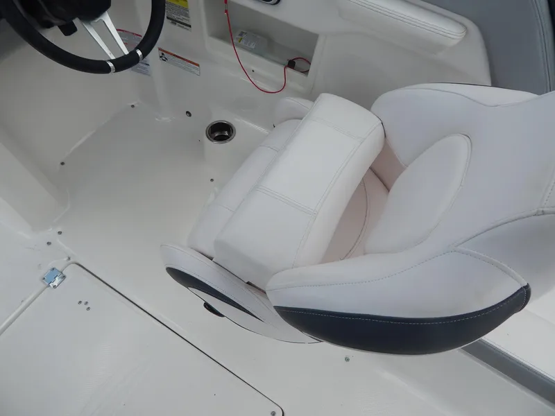 Slide: The Image of 2021 Chaparral 23 SSi boat interior with white seating and steering wheel. - 10