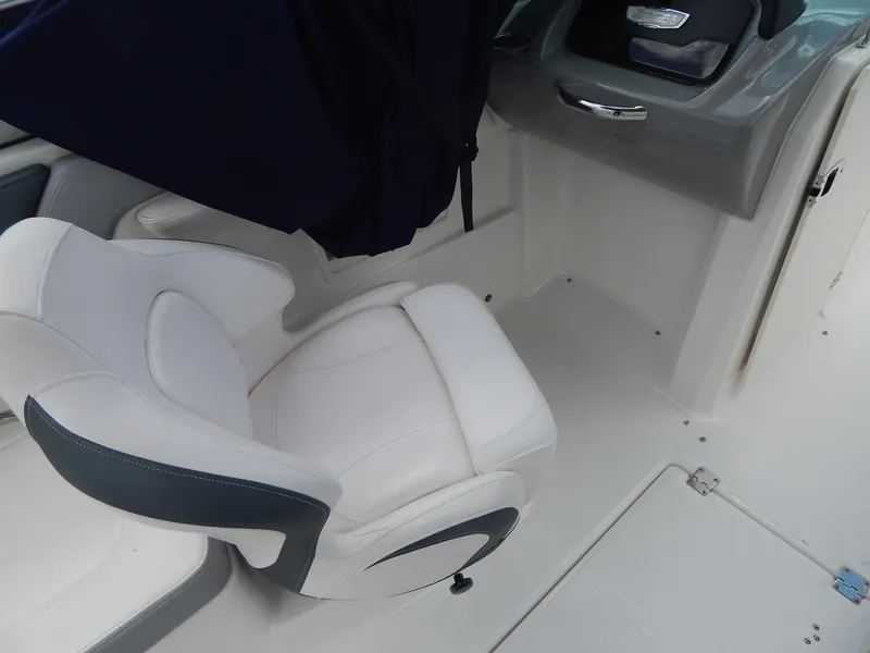 Slide: The Image of 2021 Chaparral 23 SSi boat interior with white and gray seating. - 11