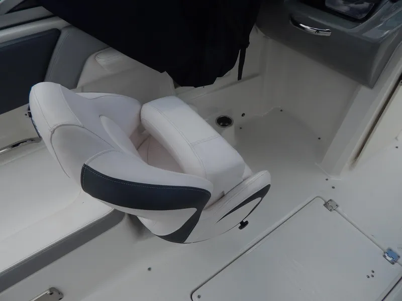 Slide: The Image of 2021 Chaparral 23 SSi boat interior with white and gray seating. - 12