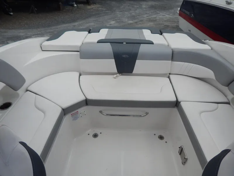 Slide: The Image of 2021 Chaparral 23 SSi boat interior with white and gray seating arrangement. - 13