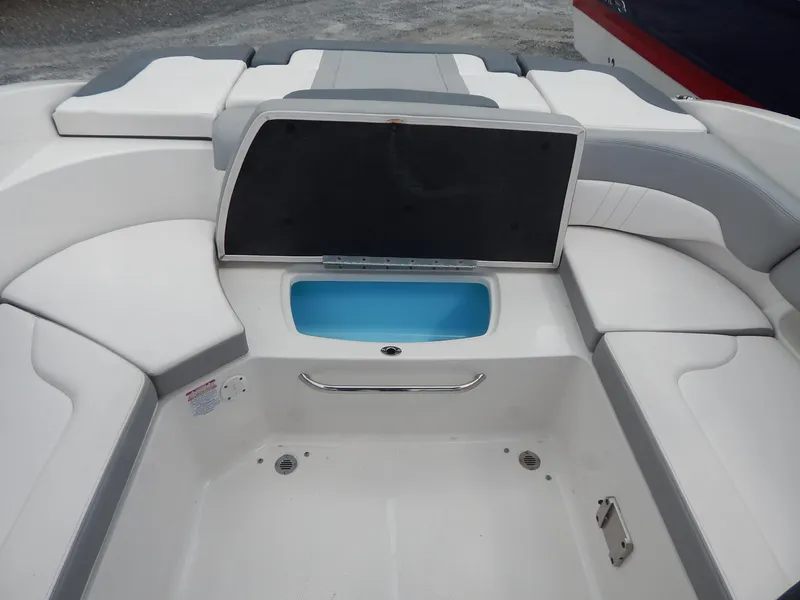 Slide: The Image of 2021 Chaparral 23 SSi boat interior with seating and storage compartment. - 14