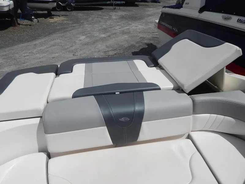 Slide: The Image of 2021 Chaparral 23 SSi boat interior with cushioned seating and storage compartment. - 16