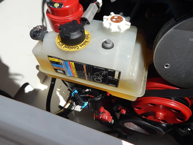 Slide: The Image of Engine compartment of 2021 Chaparral 23 SSi showing coolant reservoir and components. - 20