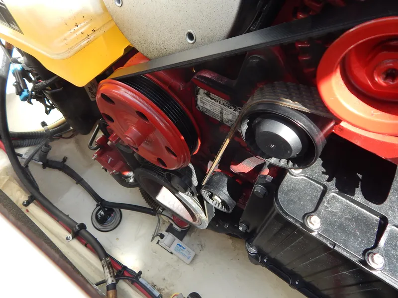 Slide: The Image of Engine components of a 2021 Chaparral 23 SSi boat, featuring belts and pulleys. - 23