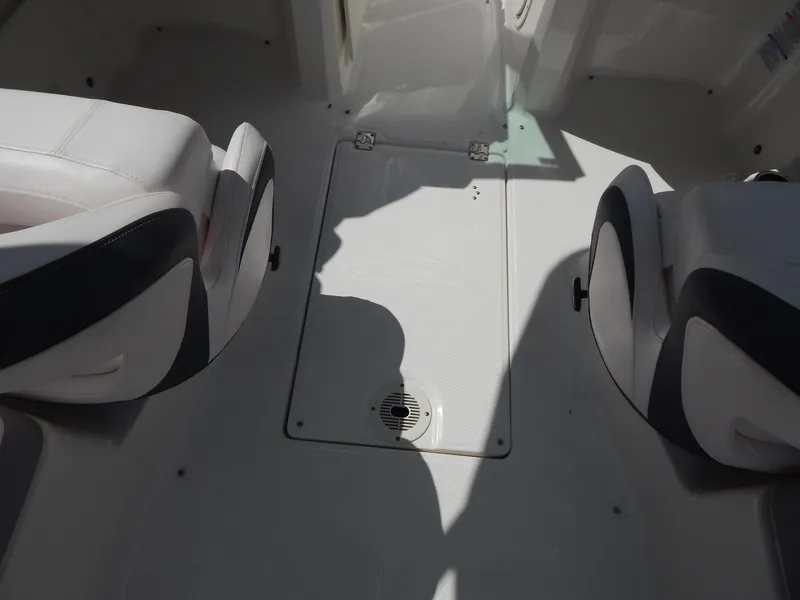 Slide: The Image of Interior of 2021 Chaparral 23 SSi boat with white seating and floor compartment. - 25