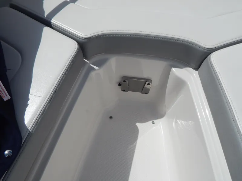 Slide: The Image of 2021 Chaparral 23 SSi boat interior storage compartment, featuring sleek white design. - 27