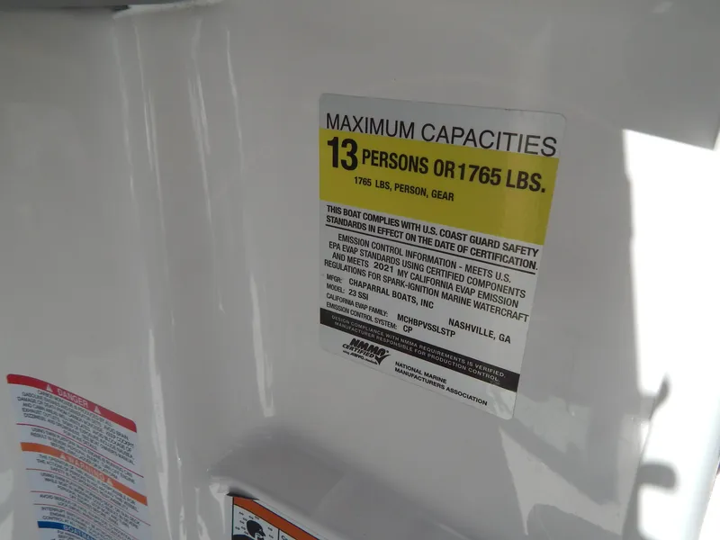 Slide: The Image of 2021 Chaparral 23 SSi capacity label: 13 persons or 1765 lbs maximum load. - 32