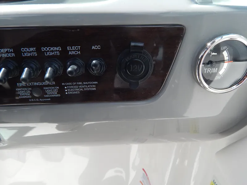Slide: The Image of Control panel of a 2021 Chaparral 23 SSi boat with switches and trim gauge. - 33