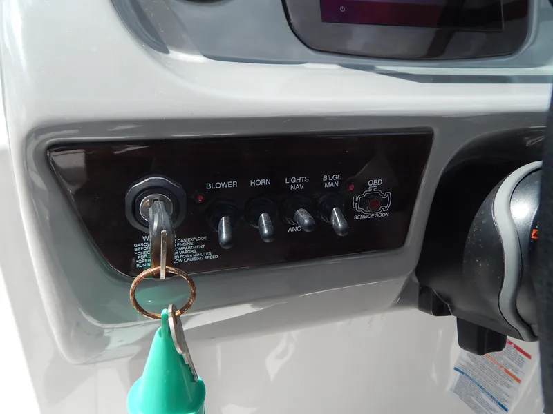 Slide: The Image of Control panel of 2021 Chaparral 23 SSi boat with ignition key and switches. - 34