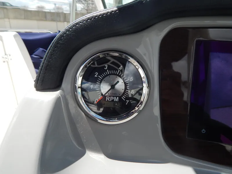 Slide: The Image of Tachometer on 2021 Chaparral 23 SSi boat dashboard, displaying RPM gauge. - 35
