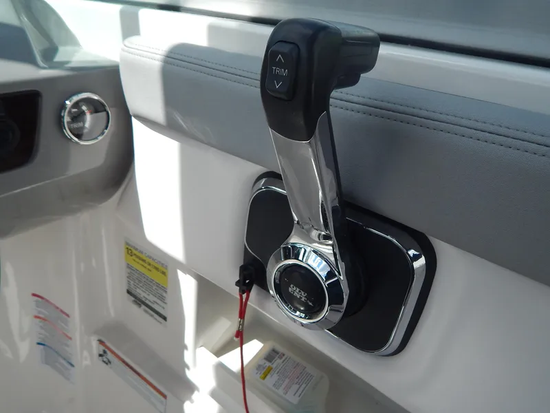 Slide: The Image of Throttle control of 2021 Chaparral 23 SSi boat, featuring sleek design and trim buttons. - 37