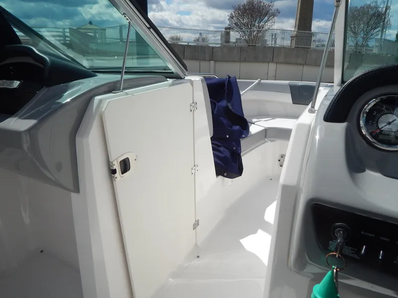 Slide: The Image of 2021 Chaparral 23 SSi boat interior with dashboard and seating area. - 38