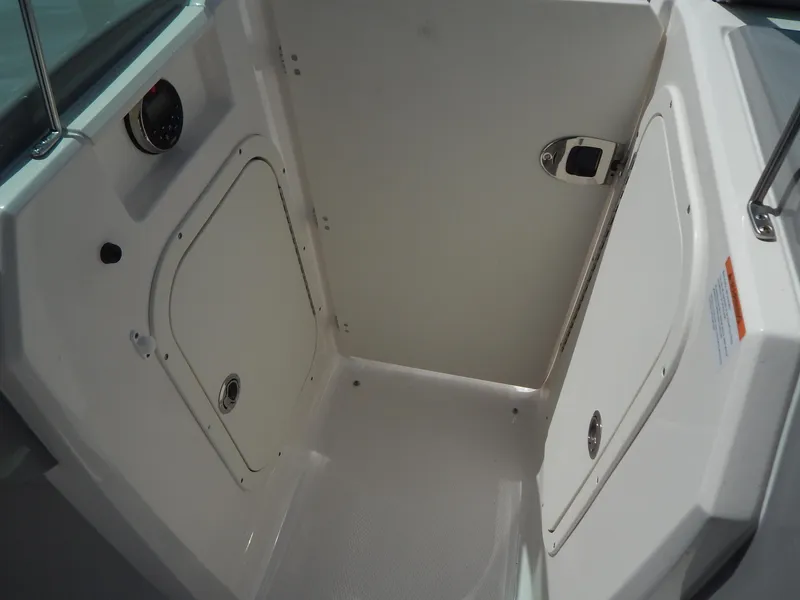Slide: The Image of 2021 Chaparral 23 SSi boat interior storage compartment with white finish. - 39