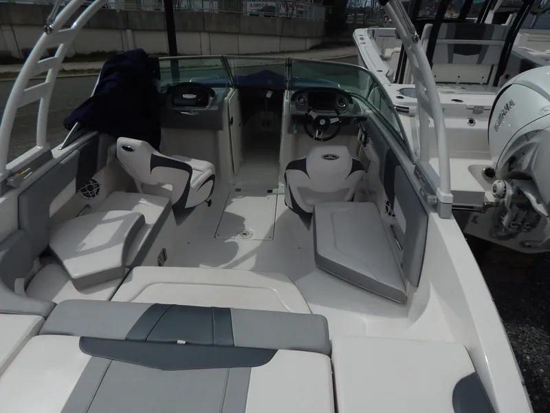Slide: The Image of 2021 Chaparral 23 SSi boat interior with seating and steering wheel. - 7