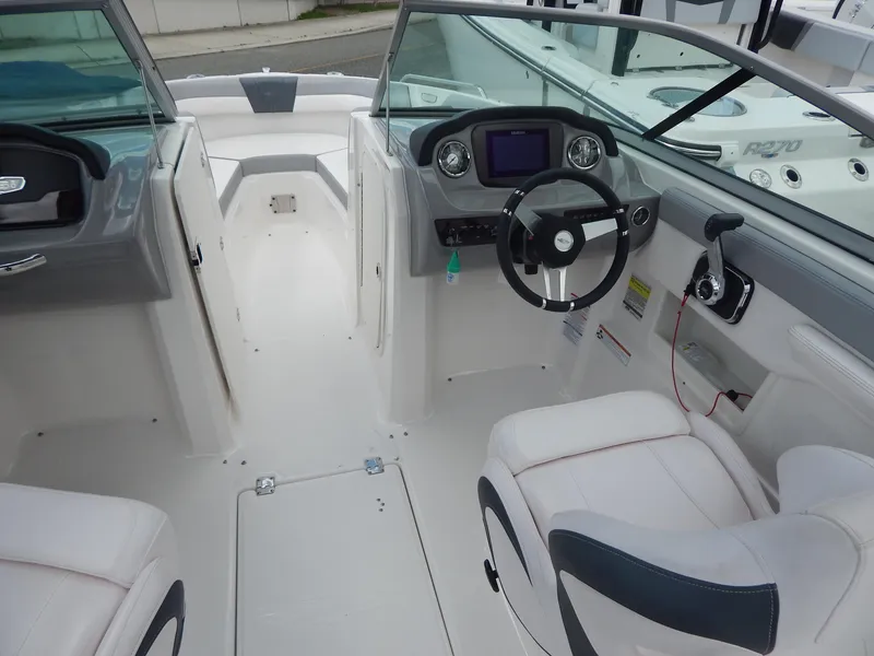 Slide: The Image of 2021 Chaparral 23 SSi boat interior with modern dashboard and seating. - 9
