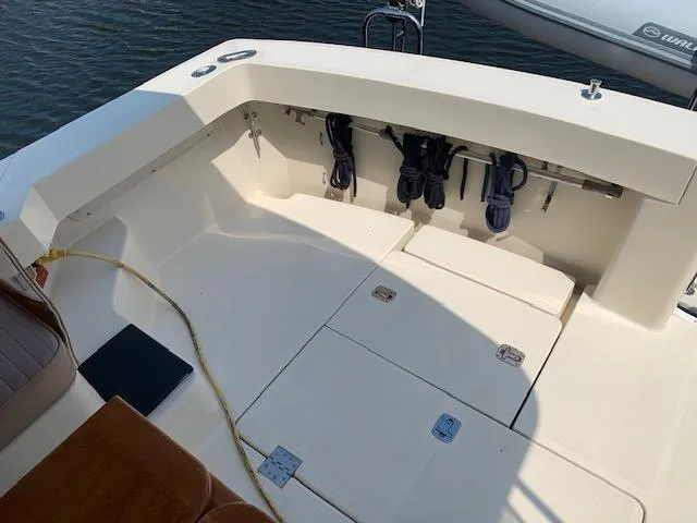 Slide: The Image of 2008 Mainship Pilot 34 boat deck with storage compartments and coiled ropes. - 19