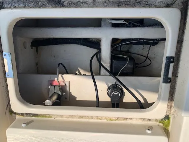 Slide: The Image of 2008 Mainship Pilot 34 boat compartment with wiring and components. - 21