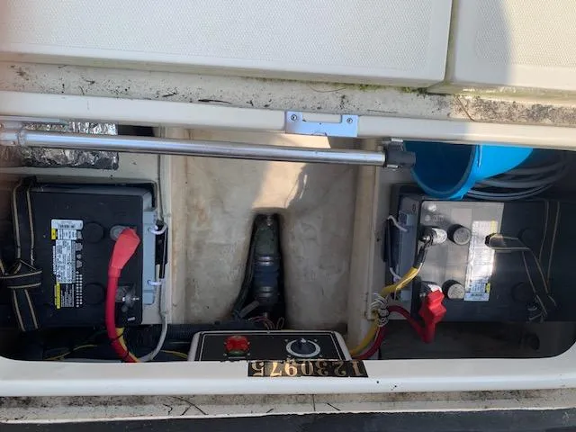 Slide: The Image of 2008 Mainship Pilot 34 boat battery compartment with wiring and control panel. - 22