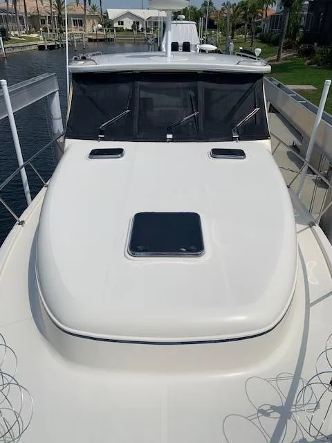 Slide: The Image of 2008 Mainship Pilot 34 boat docked, featuring sleek white deck and cabin windows. - 28