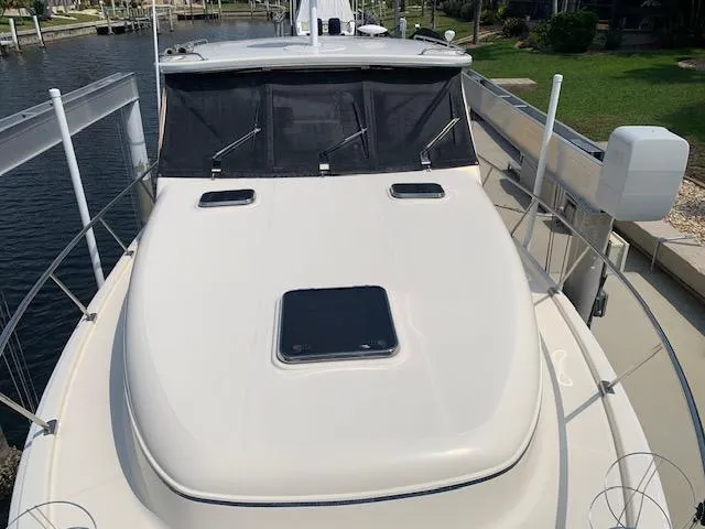 Slide: The Image of 2008 Mainship Pilot 34 boat docked, featuring a sleek deck and windshield. - 29