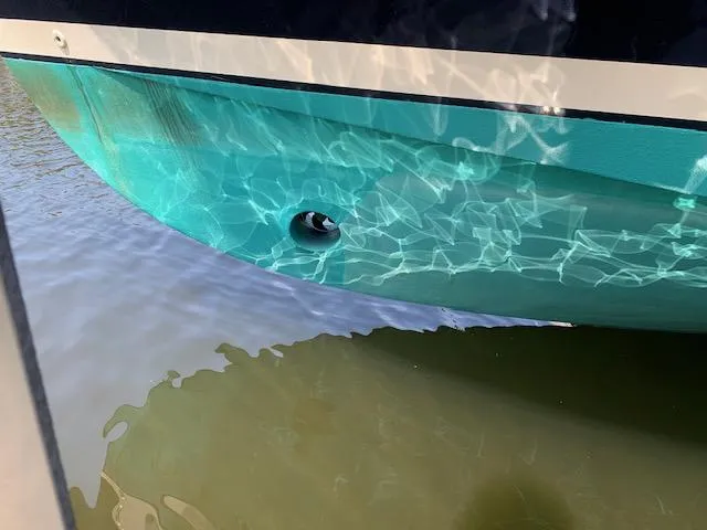 Slide: The Image of 2008 Mainship Pilot 34 boat hull reflecting water patterns. - 31