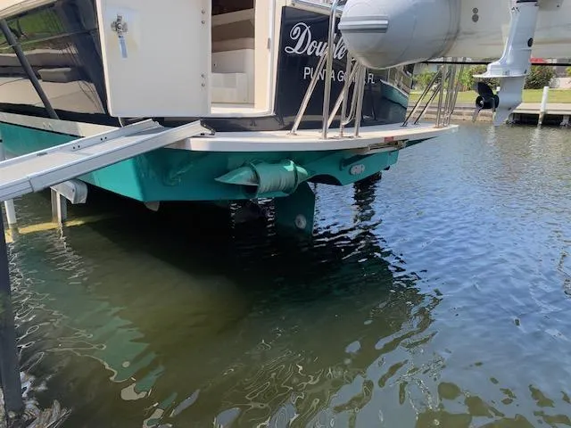 Slide: The Image of 2008 Mainship Pilot 34 boat docked, showing stern and propeller in water. - 32