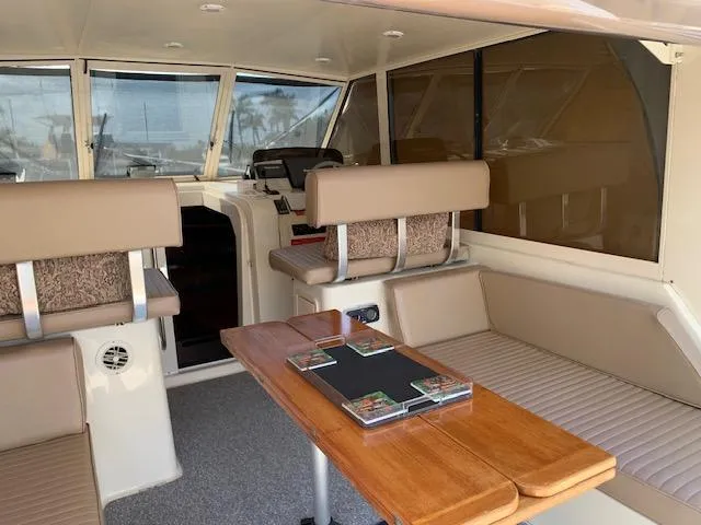 Slide: The Image of Interior of 2008 Mainship Pilot 34 boat with seating and table. - 4