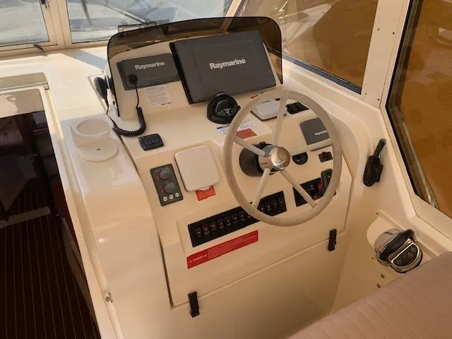 Slide: The Image of 2008 Mainship Pilot 34 helm with Raymarine electronics and steering wheel. - 5