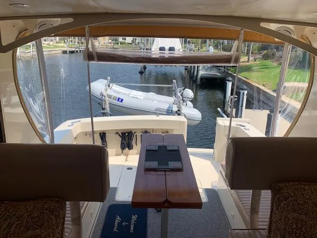Slide: The Image of 2008 Mainship Pilot 34 interior view with docked boat and waterway. - 6