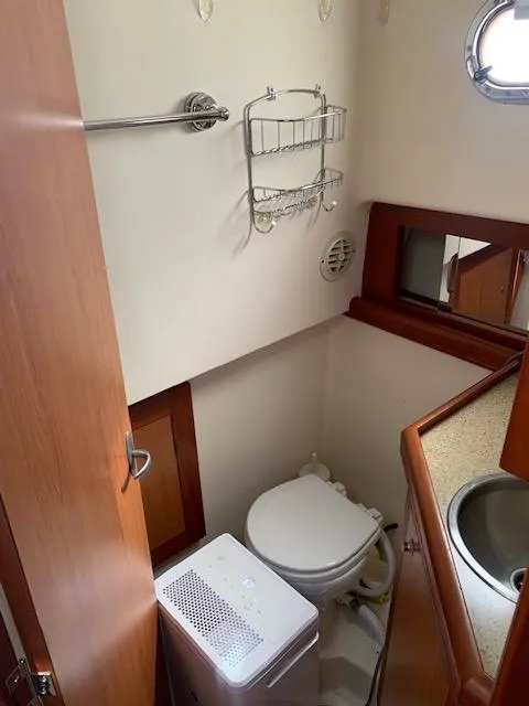 Slide: The Image of 2008 Mainship Pilot 34 boat bathroom with toilet, sink, and storage. - 8