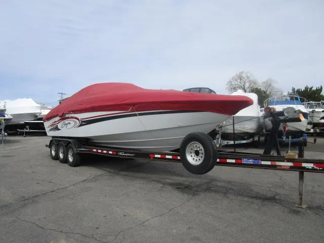 The Image of 2001 Baja 292 Islander boat on trailer with red cover in parking lot. - 1