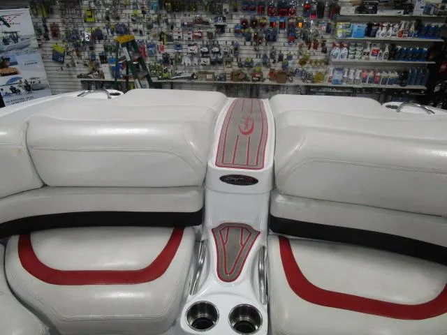 Slide: The Image of Interior of a 2001 Baja 292 Islander boat with white and red seating. - 11