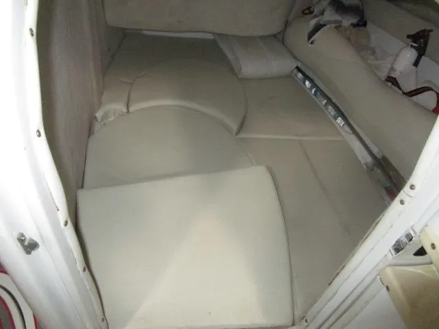 Slide: The Image of 2001 Baja 292 Islander boat interior cabin with cushioned seating and storage. - 14