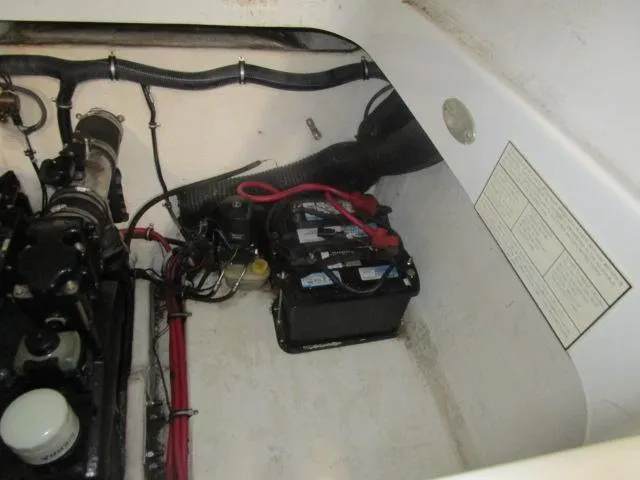 Slide: The Image of Engine compartment of a 2001 Baja 292 Islander boat, showing battery and wiring. - 18