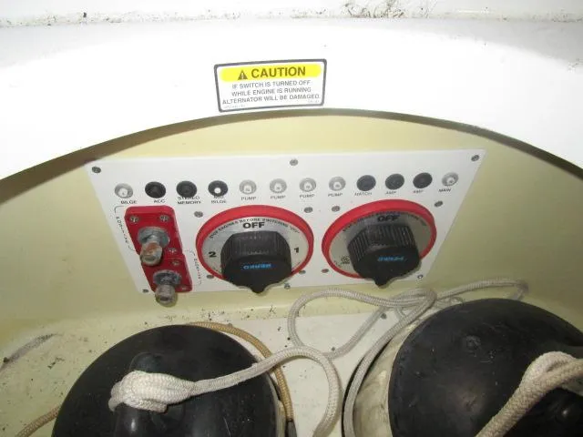 Slide: The Image of Control panel of a 2001 Baja 292 Islander boat with caution label and switches. - 19