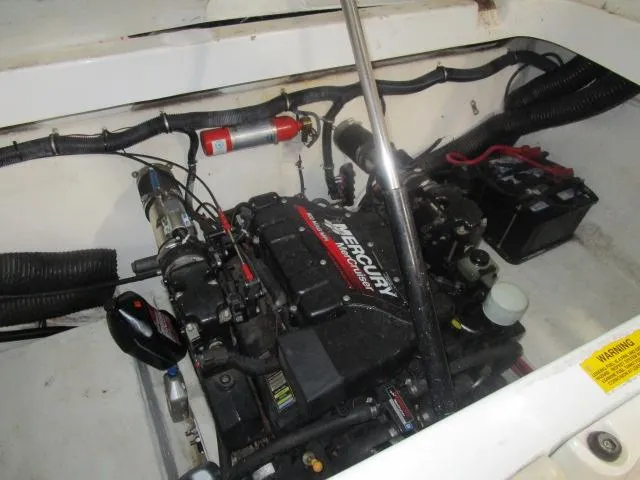 Slide: The Image of Engine compartment of a 2001 Baja 292 Islander boat with Mercury engine and fire extinguisher. - 21